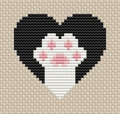 a cross stitch heart with black and white cat's paw prints