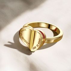 Introducing the "Chapters of Love Engraved Statement Ring," a meaningful emblem of love's profound virtues. Crafted with intention, the ring unfolds like a tenderly worn book, its heart-shaped form revealing the enduring words "Love is patient, Love is kind." Each inscription calls to mind the timeless narratives of devotion, inviting the wearer to live out these virtues.Far more than a mere adornment, this ring is a daily narrative, symbolically opening to share a message that resonates with th Personalized Heart-shaped Signet Ring Gift, Personalized Heart-shaped Signet Ring For Valentine's Day, Valentine's Day Letter-shaped Engraved Jewelry, 14k Gold Heart-shaped Signet Ring Gift, Heart-shaped Yellow Gold Signet Ring For Valentine's Day, Hope Strength, Heart Crown, Cross Gift, Fidget Rings