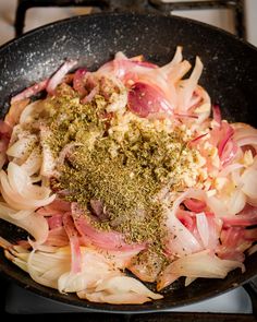 onions and seasoning in a skillet on the stove