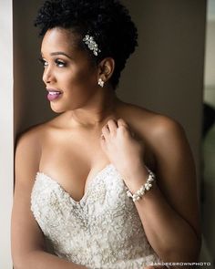 a woman in a wedding dress is posing for the camera with her hand on her shoulder