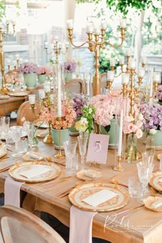 the table is set with plates and place settings for formal dinnereons, which are decorated with gold rimmed china