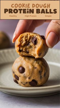 a person holding a chocolate chip cookie dough ball on top of each other in front of a plate