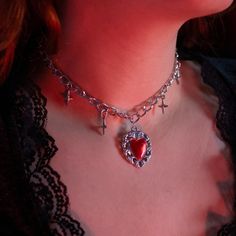 ❤️🔥 An edgy fusion of passion and rebellion. The necklace features a striking red heart charm adorned with celestial stars, suspended from a rugged chain. The rebellious grunge aesthetic meets cosmic allure in this bold accessory, creating a look that's both daring and enchanting. ❤️🔥 Let the fiery red heart symbolize your untamed spirit, surrounded by the celestial chaos of stars that adds a touch of cosmic rebellion. The "Fiery Heart" Necklace effortlessly complements grunge-inspired fashion Punk Style Heart Necklace For Valentine's Day, Punk Heart Necklace As A Gift, Edgy Metal Choker For Valentine's Day, Punk Metal Heart Necklace For Valentine's Day, Punk Style Metal Heart Necklace For Valentine's Day, Punk Silver Jewelry For Valentine's Day, Emo Heart-shaped Jewelry For Valentine's Day, Silver Punk Jewelry For Valentine's Day, Valentine's Day Punk Silver Jewelry