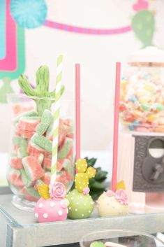 there are many candys on the table with strawberries and cactuses in them