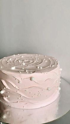 a white frosted cake sitting on top of a table