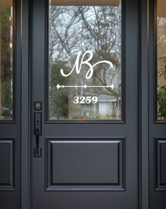 a black front door with a glass window and the initials blg on it