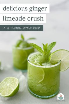 two glasses filled with limeade drink and garnished with mint leaves, sitting on a white surface