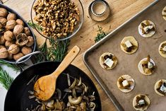 an assortment of food is being prepared in pans on a table with other foods