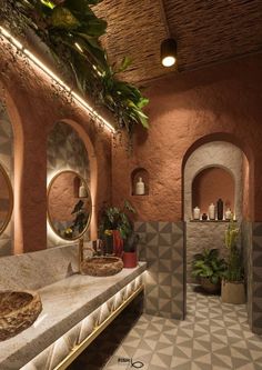 a bathroom with two sinks, mirrors and plants in the corner on the wall next to each other