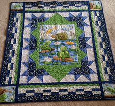 a quilted table topper with an image of a pond