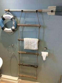 a bathroom with a ladder and towel rack