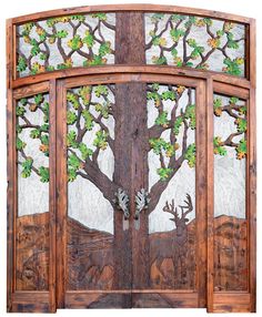 an image of a hand carved wooden door with deer and tree on the glass window