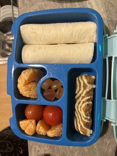 a blue plastic container filled with food on top of a counter