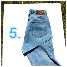 a pair of blue jeans with the number five on it, sitting next to an image of grass