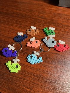 several pieces of perler bead sitting on top of a wooden table