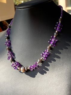 "This choker to collar length piece is graced with gorgeous Grade AAA faceted violet purple Amethyst briolette teardrop beads (approx 8mm long), and accented with faceted rondelles of rare Black Labradorite of deep black/brown with flashes of blue iridescent fire. Silver silver spacers and a decorated wire work Bali silver focal contrast beautifully with the semi precious stones for a striking look. The faceted faces of the beads reflect light in a stunning way. Silver plated hook clasp and exte Purple Amethyst Faceted Bead Crystal Necklaces, Purple Amethyst Crystal Necklaces With Faceted Beads, Purple Amethyst Crystal Necklace With Faceted Beads, Purple Amethyst Necklace With Faceted Beads, Amethyst Briolette Necklace With Faceted Beads, Purple Faceted Amethyst Crystal Necklaces, Purple Faceted Amethyst Crystal Necklace, Teardrop Amethyst Gemstone Beads Necklaces, Faceted Amethyst Briolette Necklace