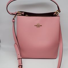 Brand: Coach Style: Town Bucket Bag / 91122 Condition: New With Tag Exterior Color: Bubblegum/Wine Interior Features: Center Zip Compartment Closure: Magnetic Snaps Hardware Color: Gold Straps: One Short Handle And One Crossbody/Shoulder Strap Approx. Measurements: 10.25" L X 10" H X 5" W Includes: Coach Hangtag No Lowball Offers Or Trades Please. Thank You For Looking! Luxury Pink Bucket Bag With Top Carry Handle, Designer Pink Satchel Bucket Bag, Pink Bucket Satchel With Top Carry Handle, Pink Crossbody Bucket Bag With Top Carry Handle, Modern Pink Bucket Bag With Detachable Strap, Designer Pink Bucket Bag With Detachable Strap, Pink Bucket Bag With Top Carry Handle, Modern Pink Crossbody Bucket Bag, Designer Pink Crossbody Bucket Bag