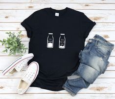 a black t - shirt with two bottles on it