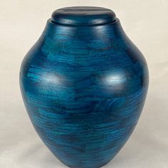 a blue vase sitting on top of a white table