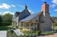 a stone building with two chimneys on the roof