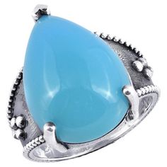 Introducing a remarkable silver ring featuring a stunning "Paraiba" color agate, known for its vivid blue hue. This exquisite piece is designed to captivate and elevate any jewelry collection. Center Stone: Agate Quantity & Weight: One agate weighing 12.12 carats. Color: Blue, displaying a vibrant "Paraiba" shade. Color Intensity: Vivid, ensuring a striking and eye-catching appearance. Shape: Pear, providing a graceful and elongated silhouette. Cut: Cabochon, emphasizing the stone's smooth surfa Bluish Green, Modern Ring, Agate Ring, Stone Cuts, Silhouette Cut, Agate Gemstone, Belleza Natural, Blue Hues, Modern Jewelry