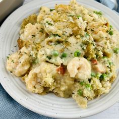 a white plate topped with pasta and shrimp