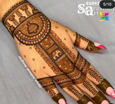 a henna design on someone's hand with pink nails