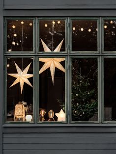 christmas decorations are displayed in the window of a house