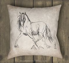 a pillow with a drawing of a horse on the front and back of it, against a wooden wall