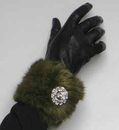 Genuine Vintage Rabbit Fur  (70's) pieces from Milano, handmade  pair of cuffs embellished with a pair of hand made brooch - Cufflinks made from rhinestones (1.5 Inches in diameter). The adjustable cuffs are fitted with 2 magnetic press dud fasteners so as to be worn either as a bracelet (one size) or as cuffs on a jacket a coat or dress (larger size). See photo above. The magnificent forest green hue of this long hair rabbit fur give it a truly vintage appeal    Dress up your little black dress or vintage jacket. Fully lined. Length: 12 Inches  30 cm Width:   4 Inches    10cm Classic Cuff Jewelry For Party, Vintage Cuff Bracelet For Party, Handmade Formal Brooches, Handmade Round Brooch For Formal Events, Handmade Cuff Bracelet For Formal Occasions, Fur Jewelry, Faux Fur Stole, Fur Cuffs, Fabulous Furs