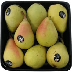 a bunch of pears sitting in a black container