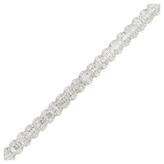 18k White Gold 6.5ctw Round Brilliant and Baguette Cut Diamond Bracelet Material: 18k White Gold Diamond Details: There are approximately 3.19ctw of Round Brilliant cut Diamonds (214 stones total). And there are approximately 3.31ctw of Baguette cut Diamonds (156 stones total). All Diamonds are approximately F/G in color and approximately VS/SI in clarity. Bracelet Length: 7" in length Bracelet Clasp: Tongue in box Clasp Total Weight: 19.2g (12.3dwt) Additional Details: This item comes with a presentation box! SKU: A30316158 Bracelet Tennis, Box Clasp, Baguette Cut Diamond, Bracelet Clasps, Baguette Cut, Tennis Bracelet, Round Brilliant Cut Diamond, White Gold Diamonds, Round Brilliant