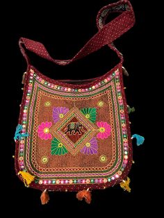 Description The Ethnic Multicolored Elegant Embellished Kutchi Style Shoulder Bag is a beautiful fusion of art, tradition, and functionality. It represents the heritage and craftsmanship of the Kutch region while serving as a unique and eye-catching accessory that adds a touch of ethnic charm and cultural elegance to any outfit. The bag’s construction is typically robust, ensuring it can withstand daily use while retaining its aesthetic appeal. It often comes with sturdy shoulder straps th Red Handwork Shoulder Bag For Festivals, Red Shoulder Bag With Handwork For Festivals, Festival Red Shoulder Bag With Handwork, Festive Red Handmade Shoulder Bag, Traditional Beaded Bags For Festivals, Embroidered Shoulder Bag For Festivals, Festive Rectangular Shoulder Bag With Mirror Work, Festive Bohemian Beaded Bag, Traditional Multicolor Rectangular Bag