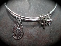 PLEASE PAY ATTENTION TO PRODUCTION AND SHIPPING TIMES AS THEY MAY BE LONGER THAN OTHER SELLERS....THANK YOU! Perfect First Holy Communion gift or special gift for a little girl! Adjustable wire bangle with small (approx. 1/2 inch) Miraculous Medal charm (double sided) and tiny cross and puffed heart charms. Comes gift boxed with ribbon. Available in stainless steel or silver plated; cross may vary from photo. For the adult size version of this bracelet ( I can add a heart charm if you wish) http Bracelet With Cross, Dachshund Jewelry, Arm Bracelets Upper, Wedding Jewelery, Wire Bangle Bracelets, Gothic Bracelet, Hammered Bangles, Signature Bracelet, Boho Bangle