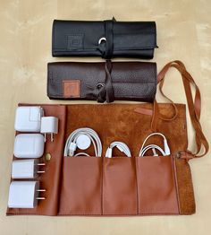 This handmade cable & charger organizer is made of genuine leather. It has three separate divisions and a pocket to keep your chargers, cables and even headphones organized. -Handmade -Colors available: Brown, Caramel Brown, Black -Materials: Genuine leather, thread, metal button Dimensions when open:  -Length: 12.75 inches -Width: 8 inches Dimensions when closed:  -Length: 8 inches -       Width: 3.5 inches -Height: 1 inch   **ALL MEASUREMENTS ARE APPROXIMATE** **LISTING IS FOR CABLE ORGANIZER Cable Organizer Diy, Leather Desk Organizer, Headphone Organizer, Diy En Cuir, Charger Organizer, Mens Leather Accessories, Diy Leather Projects, Charger Case, Charger Holder