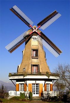 an old building with three windmills on top