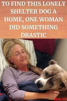 a woman laying in bed with her dog