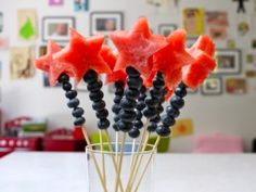 watermelon stars and blackberries in a glass with toothpicks on the table