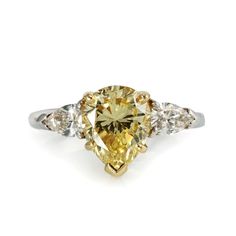 This Pear Shape Natural Fancy Intense Yellow is flanked by 2 colorless side pear shape diamonds. This ring is something different. Yellower than a Fancy Yellow its intense color vibrates with brilliance. If your looking for a natural Fancy Yellow diamond, this is one your friends won't have. Center diamond is GIA certified and can be sized to most finger sizes.Center Diamond Weight: 2.50Condition: Excellent.Stock: 96555 Fancy Yellow Diamond Ring, Pear Shaped Diamond Engagement Rings, Emerald Diamond Earrings, Diamond Chain Necklace, Emerald Cut Diamond Ring, Yellow Diamond Rings, Fancy Yellow Diamond, Three Stone Engagement, Three Stone Engagement Rings