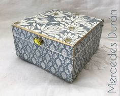 a blue and white box with flowers on it