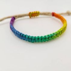 a rainbow bracelet on a white background