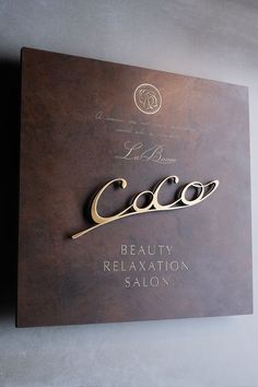 a sign that is on the side of a wall saying coco beauty and relaxation salon