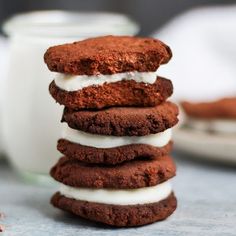 a stack of chocolate cookies with white frosting