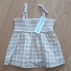 The Leilani Gingham Smocked Top Spring Gingham Smocked Top With Smocked Bodice, Summer Smocked Bodice Top For Picnic, Summer Picnic Top With Smocked Bodice, Spring Gingham Top With Smocked Bodice, Spring Gingham Smock Top, Spring Plaid Smocked Top With Ruffles, Summer Smocked Top For Picnics, Summer Cotton Plaid Smocked Top, Summer Plaid Cotton Smocked Top