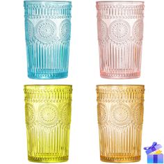 four different colored glass tumblers sitting next to each other