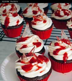 red velvet cupcakes with white frosting and sprinkles on top