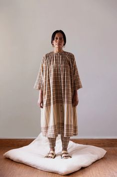 An airy, anti-fit muslin cotton dress that grazes the calf and gathers around the neck and shoulders. 3/4-quarter sleeves with hand-embroidered cuff details on silk. This Kaneer Dress is made from airy, anti-fit muslin cotton that grazes the calf and gathers around the neck and shoulders. This design includes 3/4-quarter sleeves with hand-embroidered cuff details on silk for added elegance and charm. Perfect for any fashion-forward individual seeking style and comfort. Mens Outerwear Fashion, Visionary Fashion, Hand Woven Textiles, Fashion 2024, Cotton Muslin, Linen Trousers, Muslin Cotton, Drawstring Pants, Quarter Sleeve