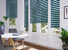 a dining room with blue blinds and white walls