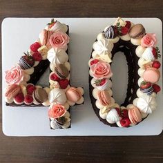 a cake shaped like the number forty with flowers on it