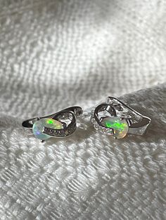 "Natural Ethiopian precious opal, blue fire and rainbow with cubic zirconia earrings.  14K White Gold over 925 sterling silver.  Measurements:  12.7 x 6.5 mm Teardrop opals: 7 x 5 mm Precious Fire Opals Some of the opal produced from the Wollo Province (Ethiopia) has an orange, yellow or reddish body color along with play-of-colour. The orange, yellow or reddish body color meets the definition of a fire opal, and the play-of-color meets the definition of a precious opal. Meeting both of these criteria, these opals could be called \"precious fire opals.\" E701B" Opal Earrings For Anniversary - Fine Jewelry, Fine Jewelry Opal Earrings For Anniversary, Anniversary Opal Earrings Fine Jewelry, Silver Opal Earrings For Wedding, Opal Earrings For Wedding, Silver Opal Earrings For Anniversary, Anniversary Silver Opal Earrings, Opal Gemstone Earrings For Anniversary, Opal Jewelry With Matching Earrings For Anniversary